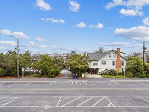 A street view with a parking lot, a building with a chimney, and a clear sky. - Coastal Escape w/ Views | Steps from Bethany Beach (Bethany Beach)