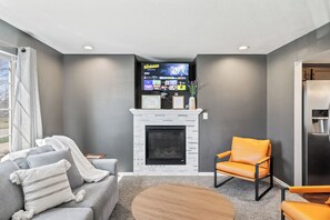 Una Smart TV, una chimenea, videojuegos, libros