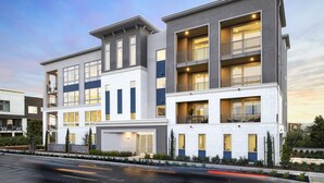 A modern multi-story residential building with a garage, large windows, and balconies.