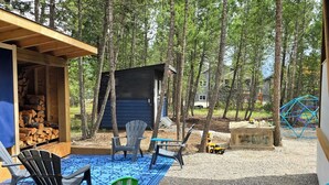 A children's play area with a slide, seating, and a covered structure. - Copper Rose Retreat B&B (Invermere)