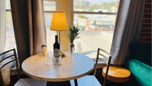 A round dining table with chairs, a lamp, a bottle, and a small plant. - Hollywood sign view/ 5 mins from universal studio (West Hollywood)