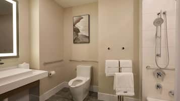 A modern bathroom with a toilet, sink, and shower.