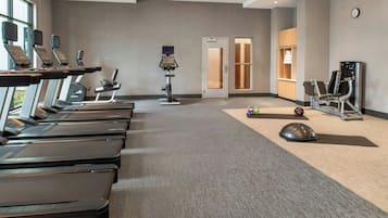 A fitness center with treadmills, a stationary bike, and a rowing machine.