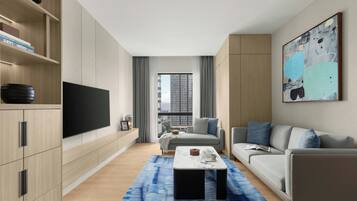 A modern living room with a flat-screen TV, a sofa, a coffee table, and a large abstract painting.