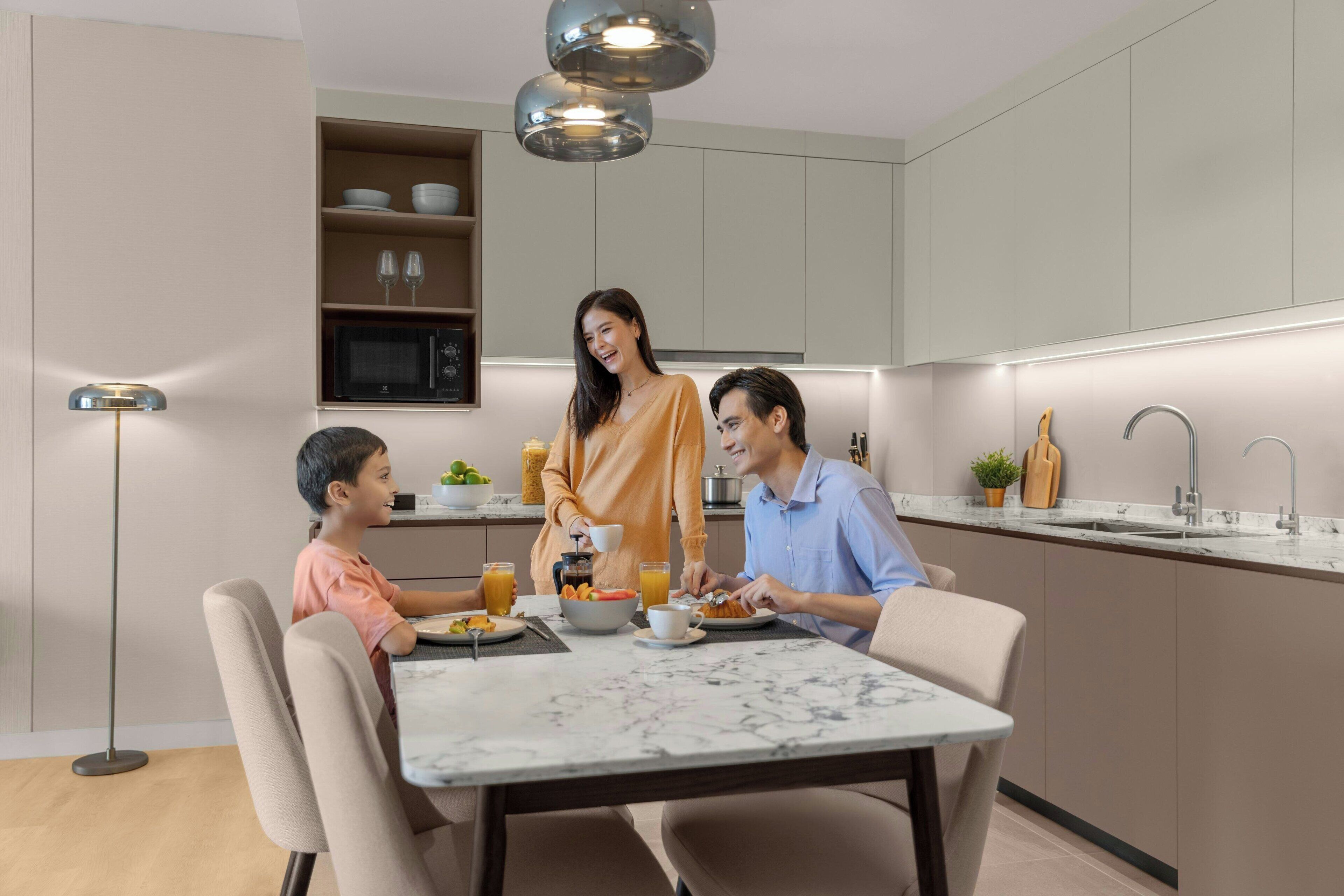A modern kitchen with a dining table, a microwave, and a sink.