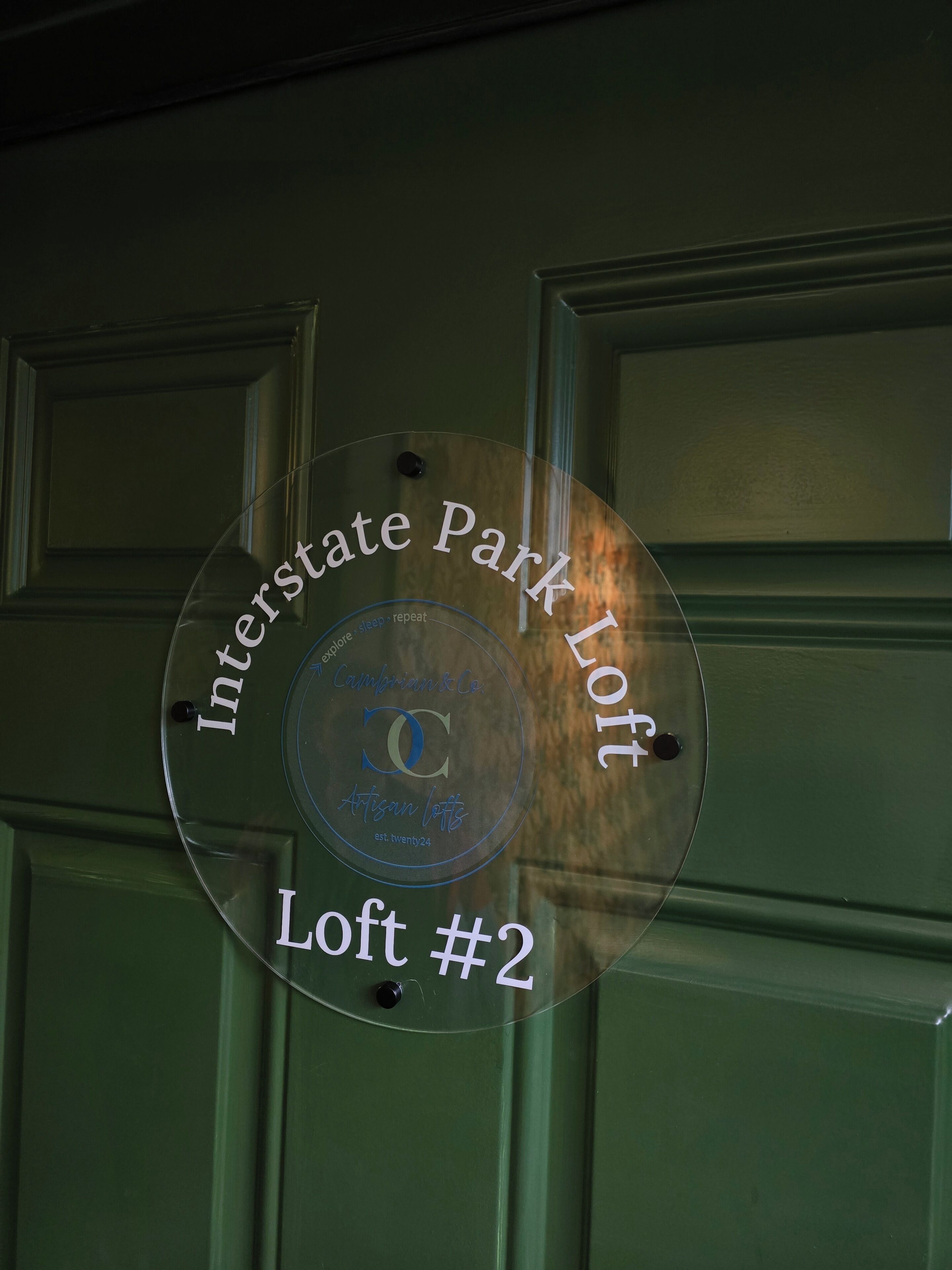 A glass plaque on a door with the text "Interstate Park Loft Loft #2".