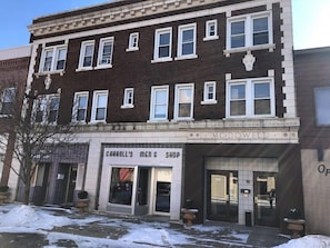 A two-story building with a ground-floor men's shop named "Carroll's Men's Shop" and a second-floor business named "McDowell."