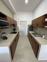 Full-size fridge, microwave, cookware/dishes/utensils