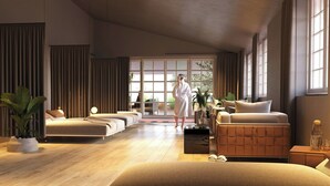 A spacious hotel room with a large bed, a sofa, and a coffee table. There is a large window providing natural light and a view of the outdoors. - Das Affalterbach, Stuttgart, Autograph Collection (Affalterbach)