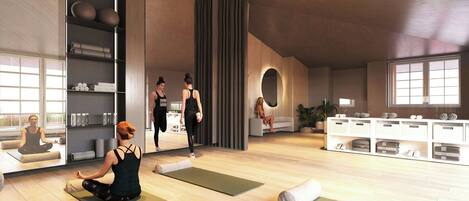 Un estudio de yoga con colchonetas, estantes con accesorios para yoga y un espejo grande.
