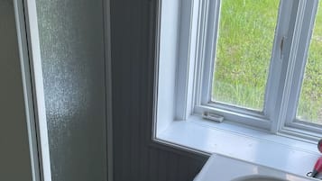 Shower, hair dryer, towels, toilet paper