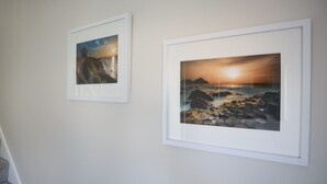 Two framed photographs on a wall.