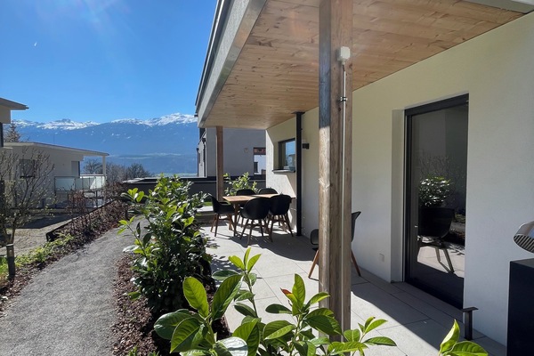 Relax on the sheltered terrace overlooking the mountains and the forest