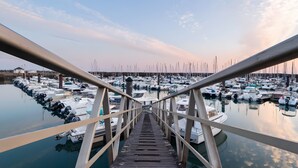 A wooden pier leading to a marina with numerous boats docked. - Apartment 'La Terrasse Du Golf' with Shared Pool, Private Terrace and Balcony (Talmont-Saint-Hilaire)