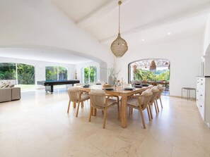 A spacious dining area with a pool table, wooden dining table, and chairs. - 400m² Villa with Padel, Pool & Volleyball (Valbonne)