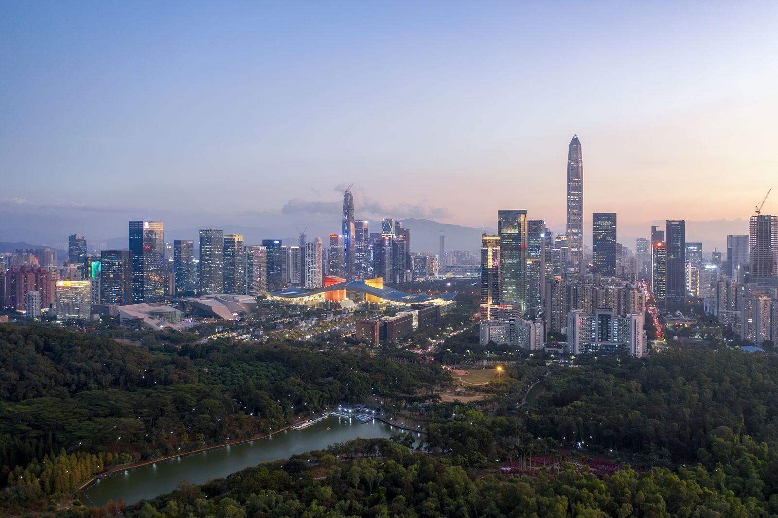A cityscape with high-rise buildings, a river, and a park area.
