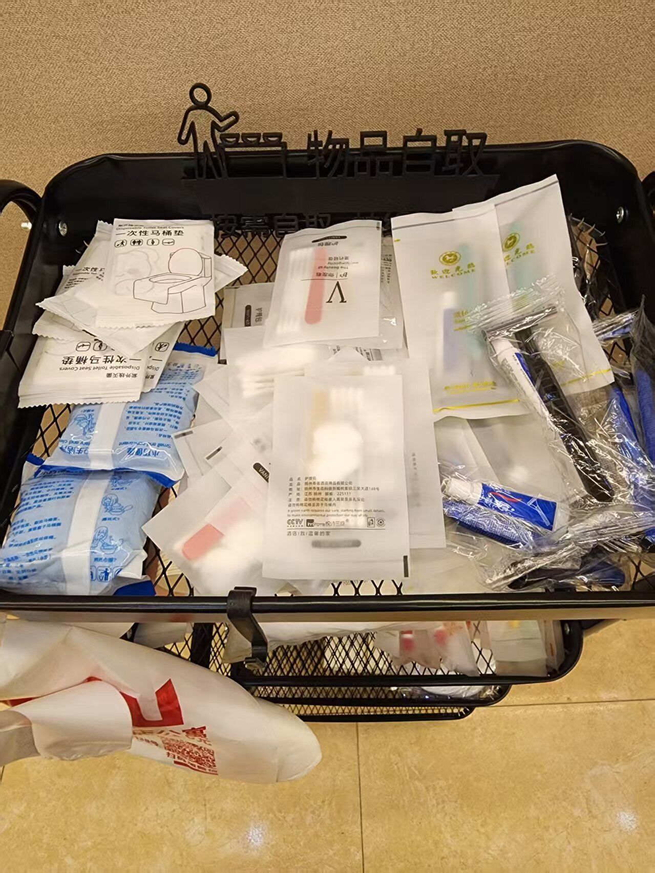 A black suitcase filled with various items including packages and a plastic bag.