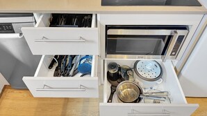 A kitchen with a built-in oven, microwave, and a stovetop. - Parkside 1 bedroom home, Whisper quiet (North Sydney)