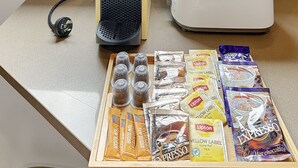 A kitchen counter with a coffee maker, toaster, and various tea and coffee packets. - Parkside 1 bedroom home, Whisper quiet (North Sydney)