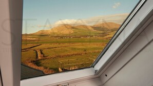 A view from a window overlooking a rural landscape with fields and a mountain in the distance. - Shepherds Rest - Four bedroom home (County Kerry)