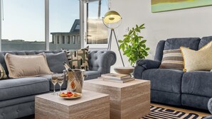 A modern living room with a grey sofa, a coffee table, and a floor lamp.