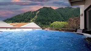 A hot tub with a mountain view.