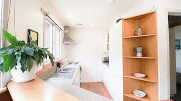 Coffee/tea maker, fridge, cookware/dishes/utensils