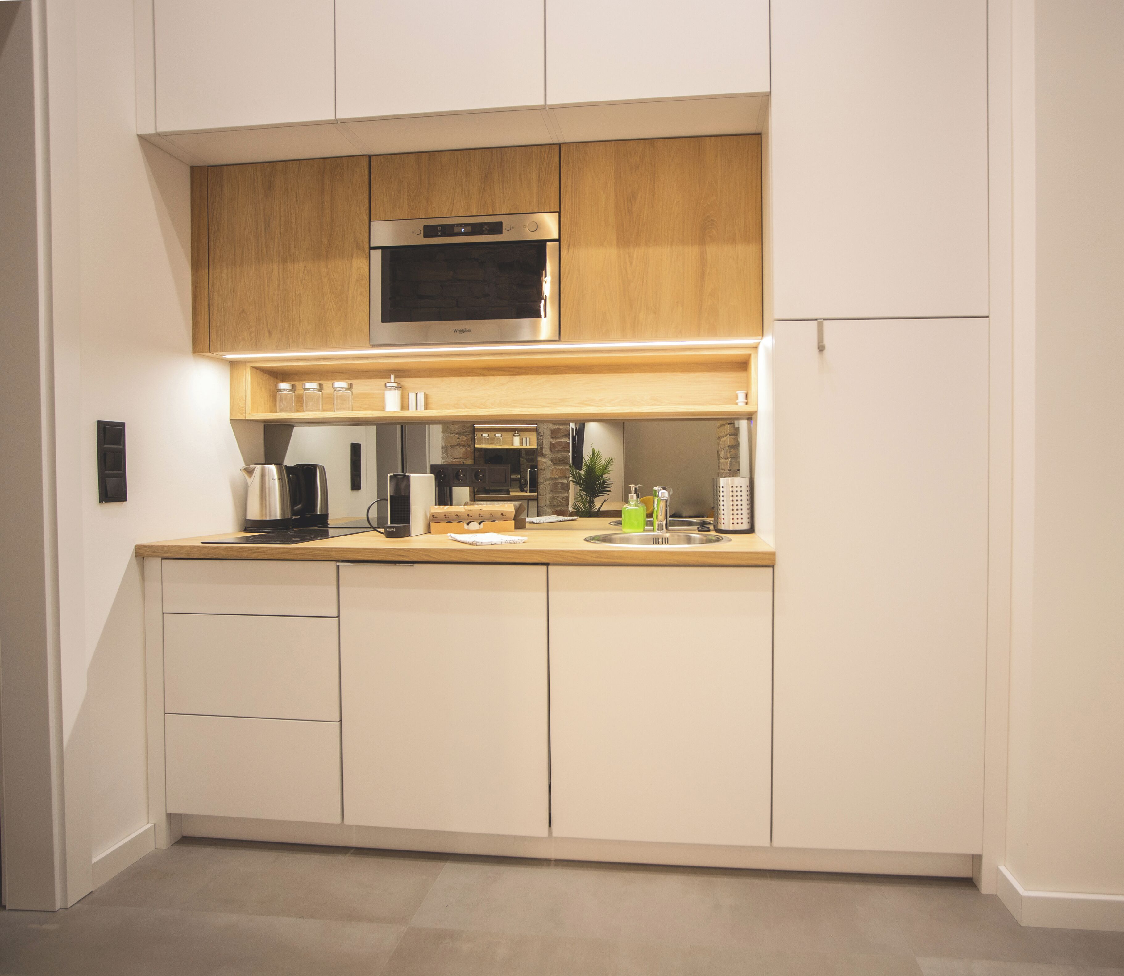 A modern kitchen with wooden cabinets, stainless steel appliances, and a clean layout.