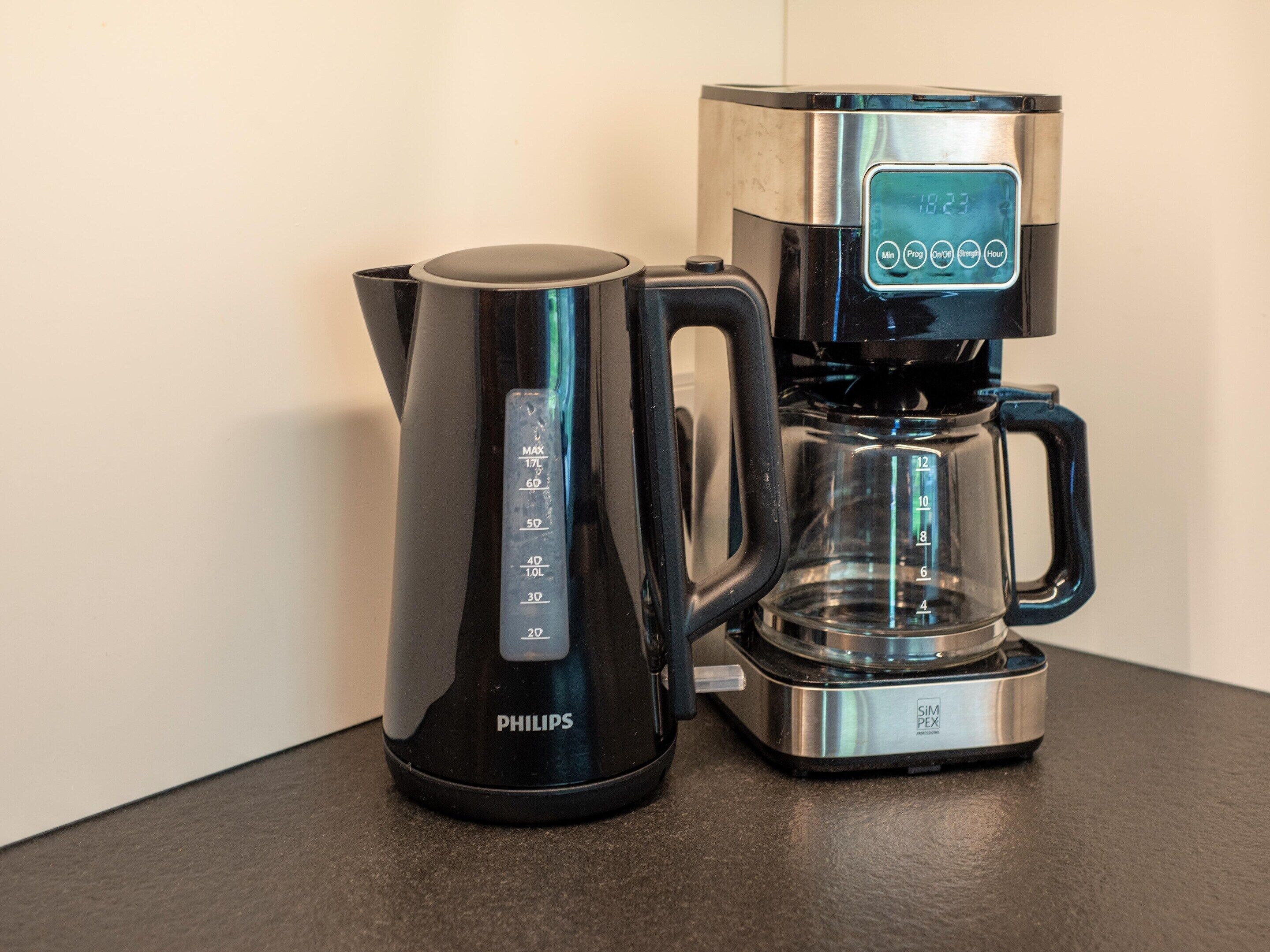 A black Philips coffee maker with a digital display and a clear glass carafe.