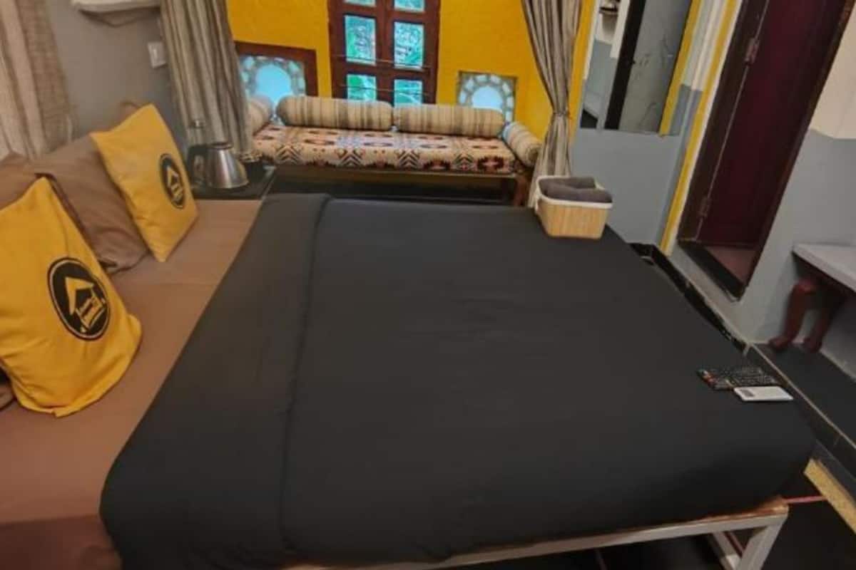A room with a bed, a sofa, and a small table.