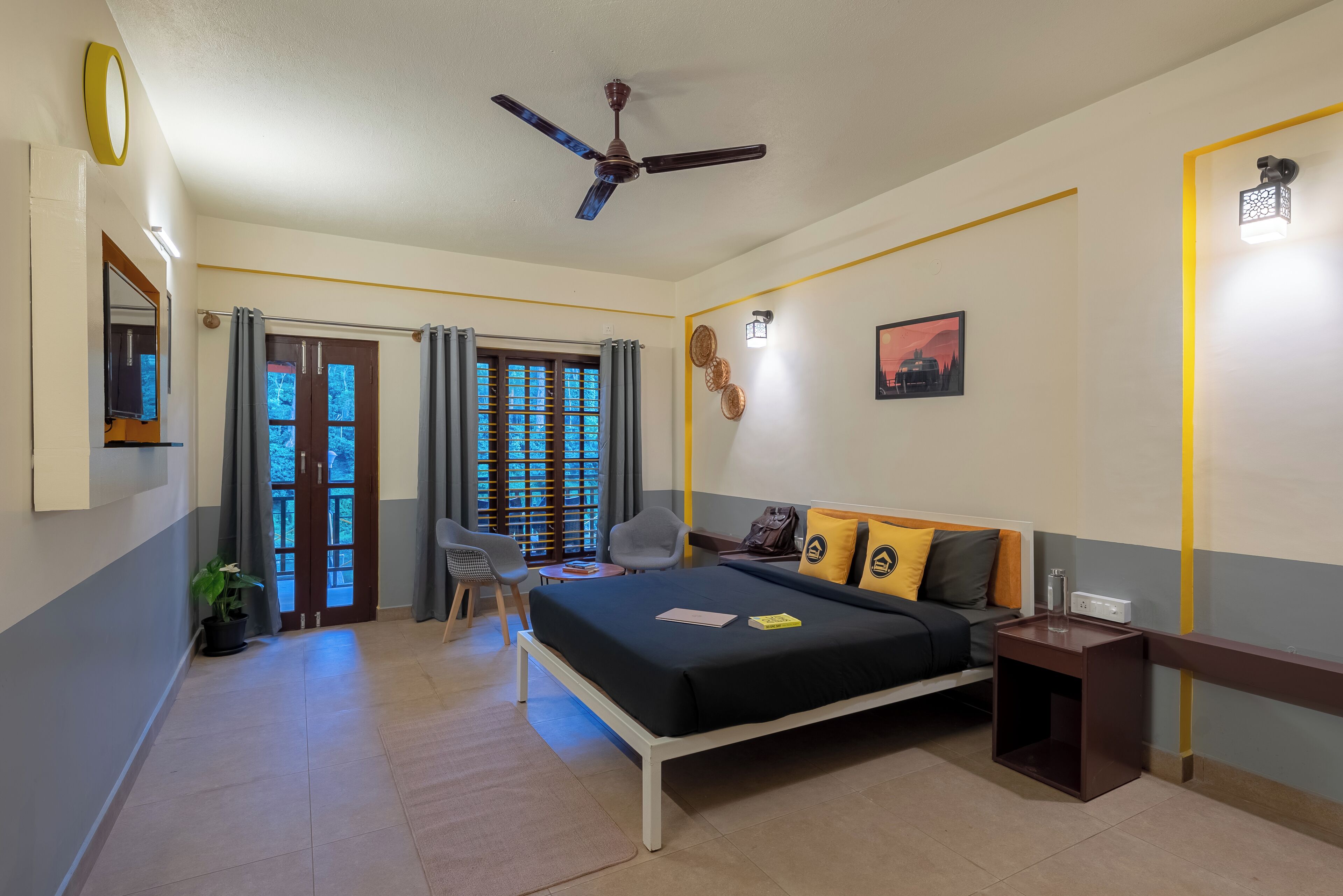 A bedroom with a bed, bedside table, and a ceiling fan.