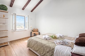 A bedroom with a bed, a window, a shelf, and a view of the outdoors. - Harmony House Vito With Lovely Terrace, Lopar, Croatia (Lopar)