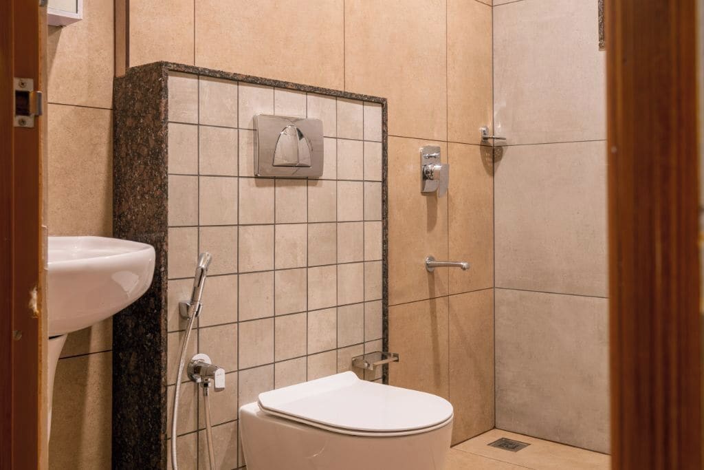A bathroom with a toilet, sink, and shower.