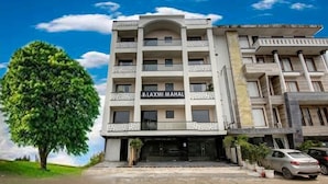 A multi-story building with a sign reading "LAXMI MAHAL". - Laxmi Mahal (New Delhi)