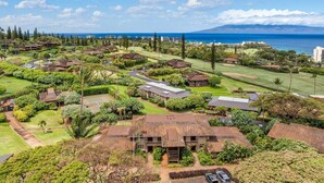 An aerial view of a residential area with houses, green spaces, and a golf course. - 2BD Pool & Resort's Amenities, Ocean Views! - Kaanapali Plantation 34 (Lahaina)