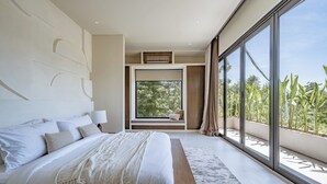 A modern bedroom with a large bed, a view of greenery outside, and a built-in bench by the window. - Villa Bōld 01 At Bōld - Luxury Villas (Pecatu)