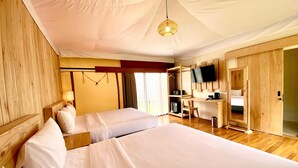 A hotel room with two beds, a desk, a TV, and a wardrobe. - Tebing View Glamping, Azana Hotel Collection (Parongpong)