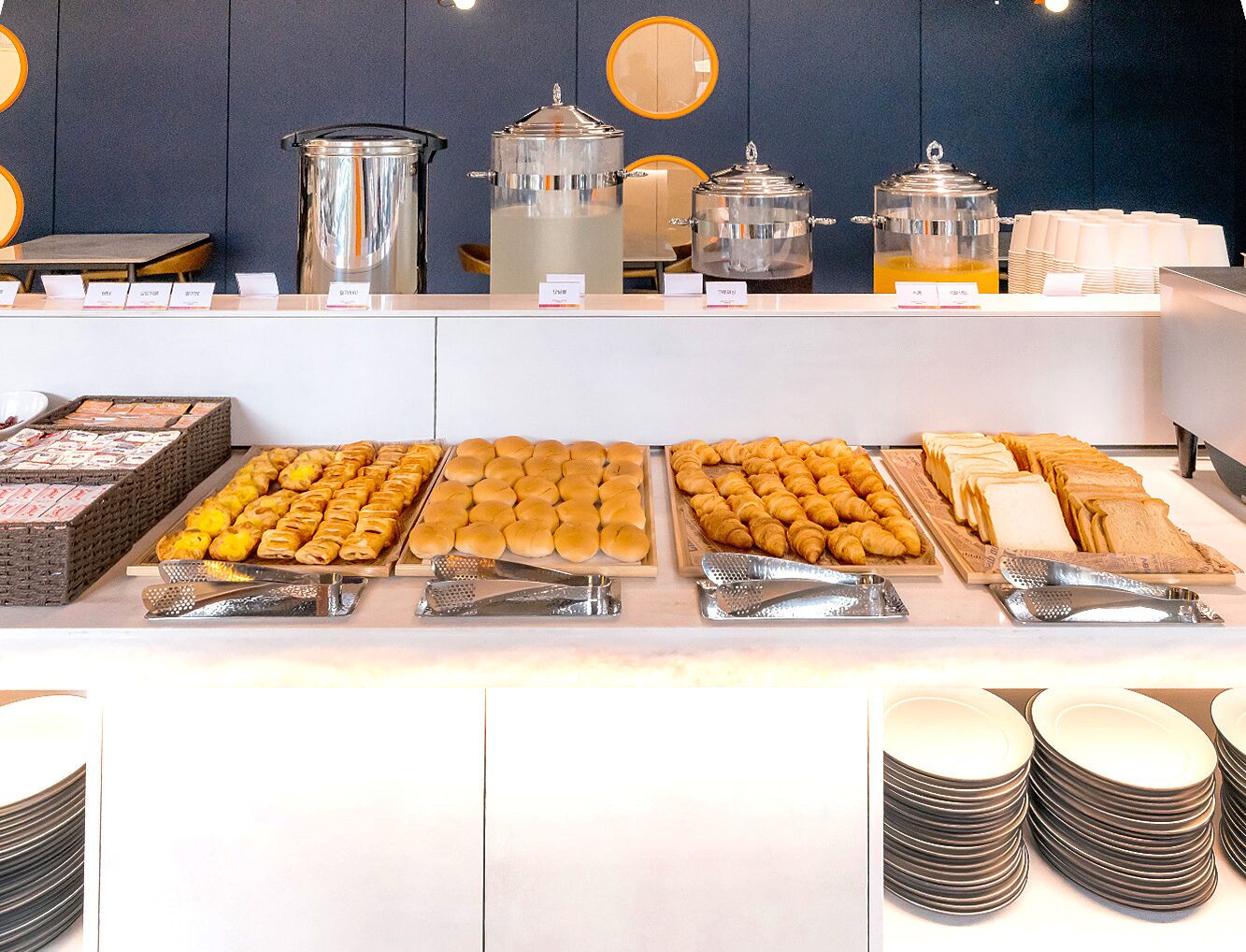 A buffet with various food items and utensils.