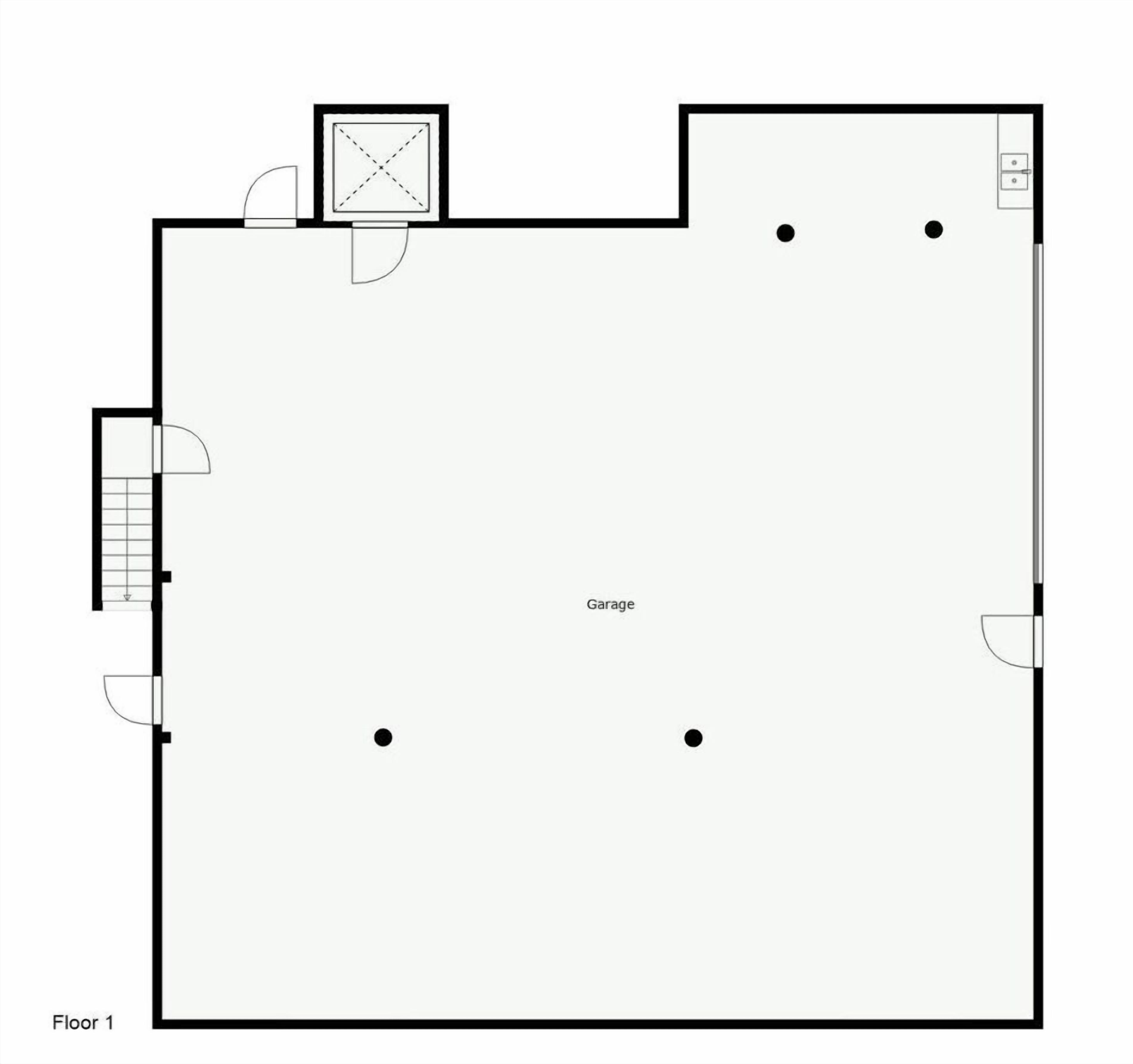 A floor plan of a building with a garage, a staircase, and a door.