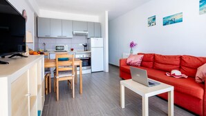 A modern apartment with a kitchen, dining area, and living room. - 309 Acapulco Playa de Las Americas (Playa de las Américas)