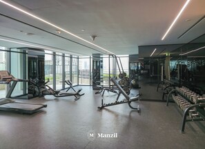 A modern gym with treadmills, elliptical machines, and weightlifting equipment. - 1BR Apt Urban Oasis near Dubai Mall (Dubai)