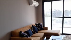 A modern living room with a sofa, a coffee table, and a side table.