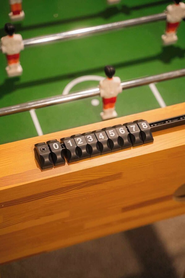 Una mesa de fútbol de mesa con barras numeradas y figuras de jugadores.