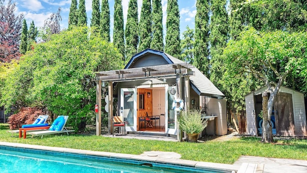 A poolside area with a covered seating area, a small building labeled 'Lounge', and a shed. - Luxury Retreat • Pool, Hot Tub • Cigar Lounge (Santa Rosa)