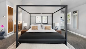 A four-poster bed in a modern bedroom with a large window, a wooden door, and a built-in wardrobe. - Luxury Retreat • Pool, Hot Tub • Cigar Lounge (Santa Rosa)