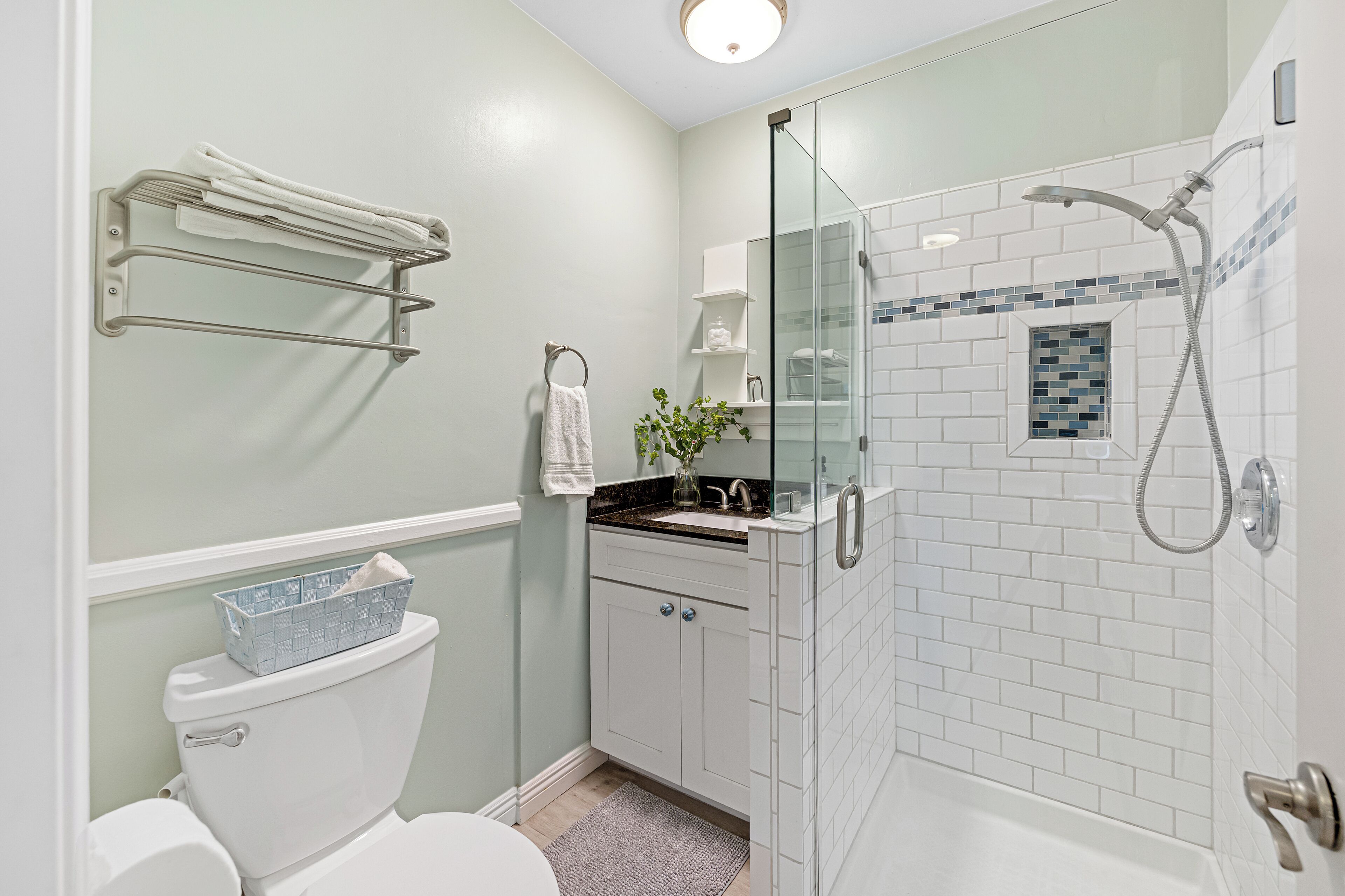 A bathroom with a toilet, sink, and shower.