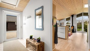 A modern kitchen with a large window, wooden ceiling, and a built-in stove. - "Gertrud" - 950m to the fjord by Interhome (Tarm)