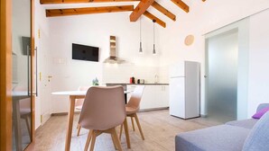 A modern kitchen with white cabinets, a stainless steel range hood, and pendant lights. - Apartment With air Conditioning, Parking and Wi-fi (Denia)