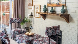 A living room with a sofa, ottoman, and a coffee table with decorative items.