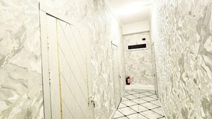 A hallway with marble walls and a tiled floor. - Best hotel (Tashkent)
